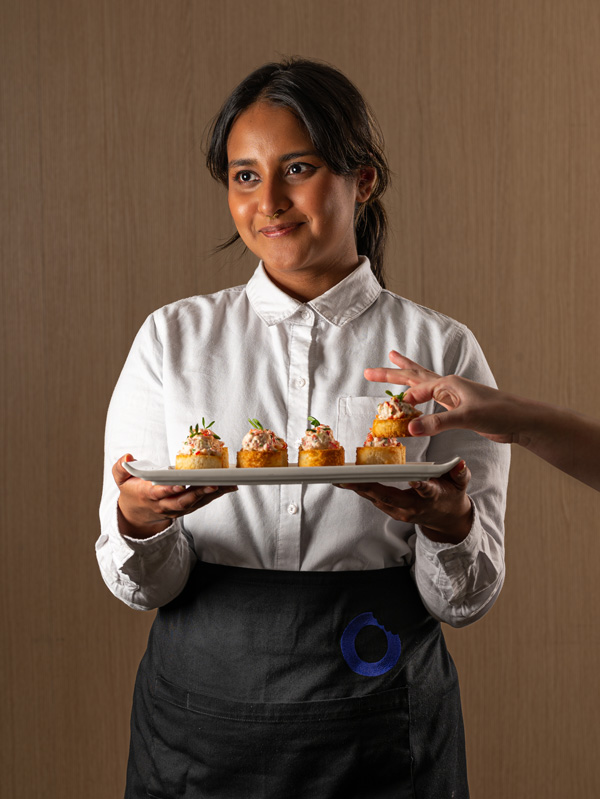 A guest takes a locally made snack from one of our servers